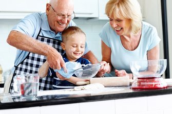 Senior couple and small kid preparing food Senior couple and small kid preparing food in the kitchen